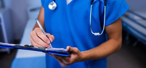 Doctor writing a report